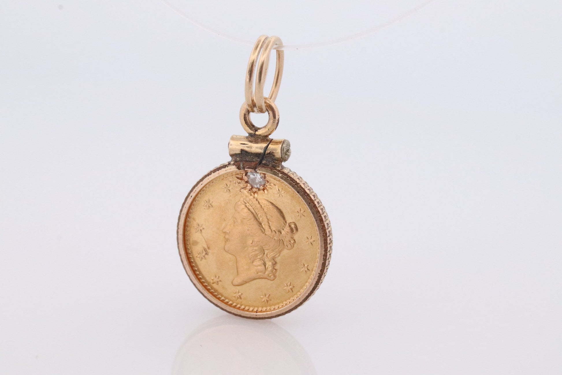 1849 US 1 dollar Liberty Head 900 gold 22K (21.6K) Gold coin set in a 14k yellow gold pendant or charm with a diamond.