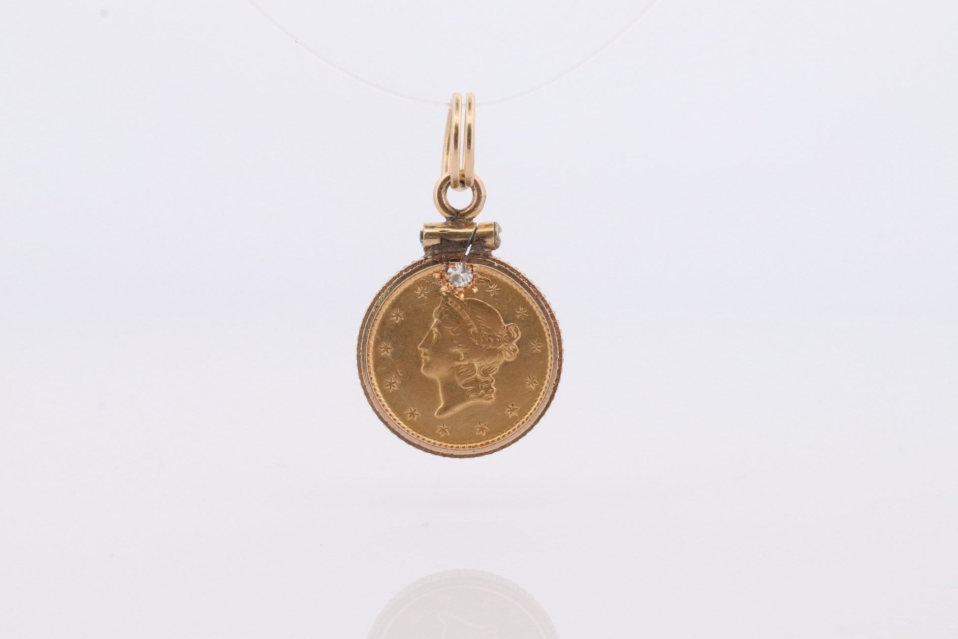 1849 US 1 dollar Liberty Head 900 gold 22K (21.6K) Gold coin set in a 14k yellow gold pendant or charm with a diamond.