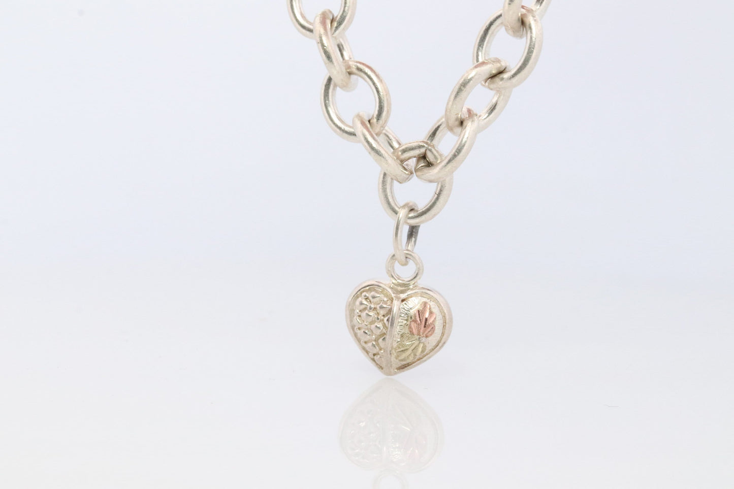 Black Hills Gold Bracelet. STERLING SILVER with 10k Multi-Tone Black Hills Gold. Large Cable with Heart charm.