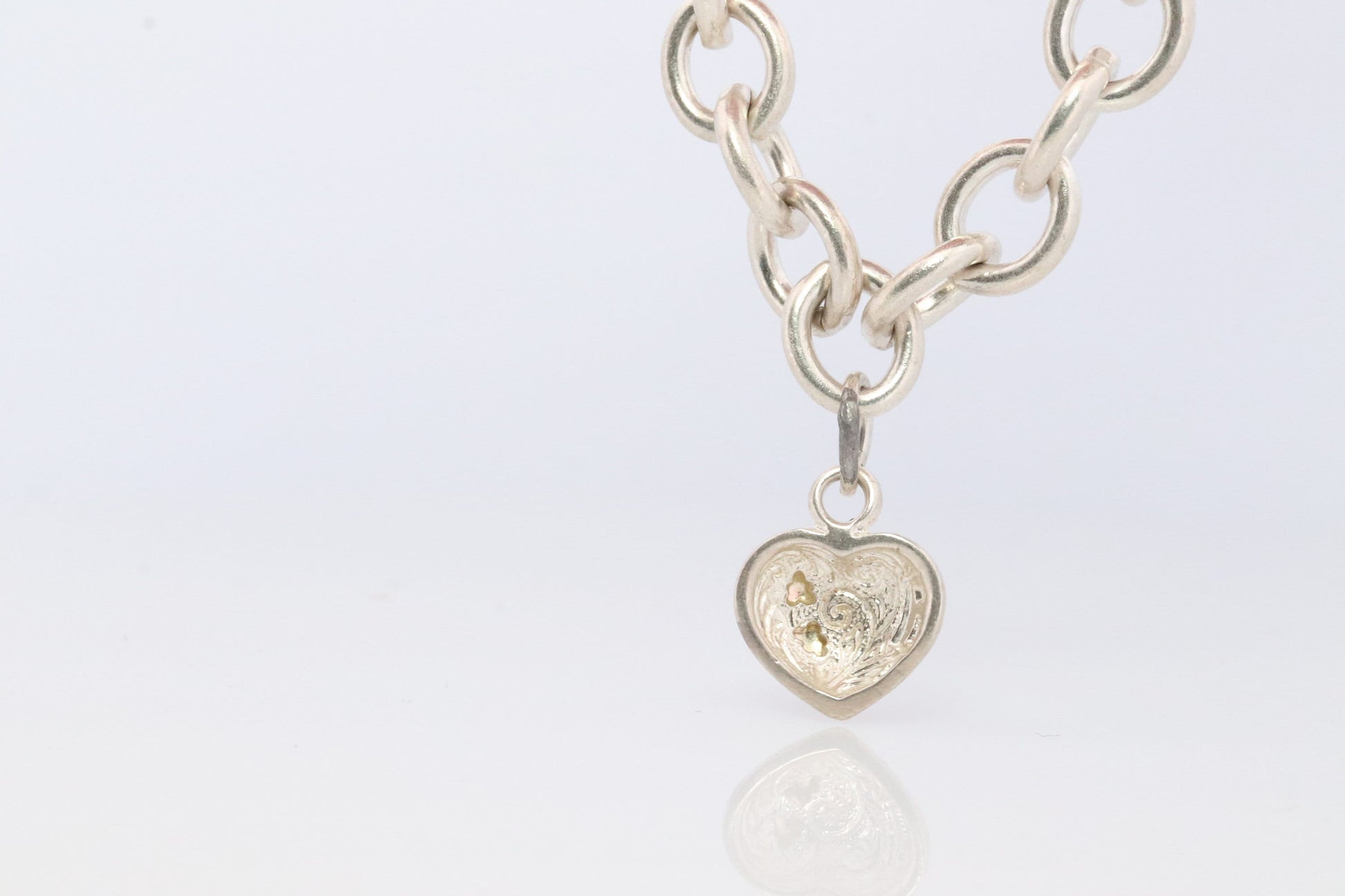 Black Hills Gold Bracelet. STERLING SILVER with 10k Multi-Tone Black Hills Gold. Large Cable with Heart charm.