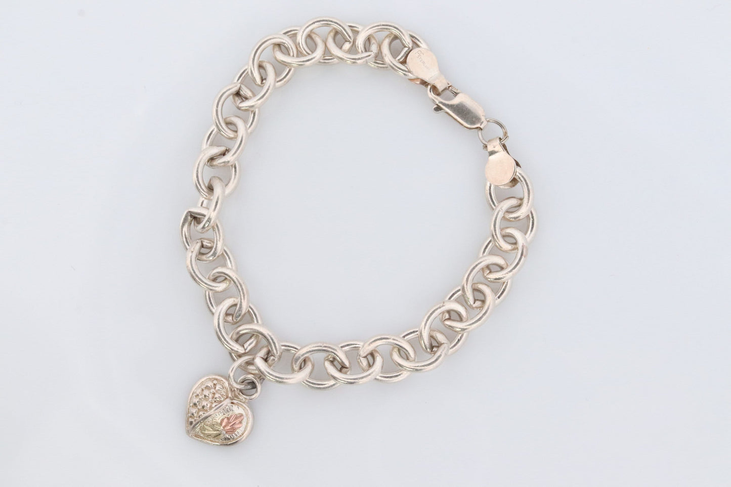 Black Hills Gold Bracelet. STERLING SILVER with 10k Multi-Tone Black Hills Gold. Large Cable with Heart charm.