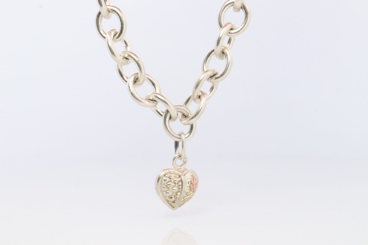 Black Hills Gold Bracelet. STERLING SILVER with 10k Multi-Tone Black Hills Gold. Large Cable with Heart charm.