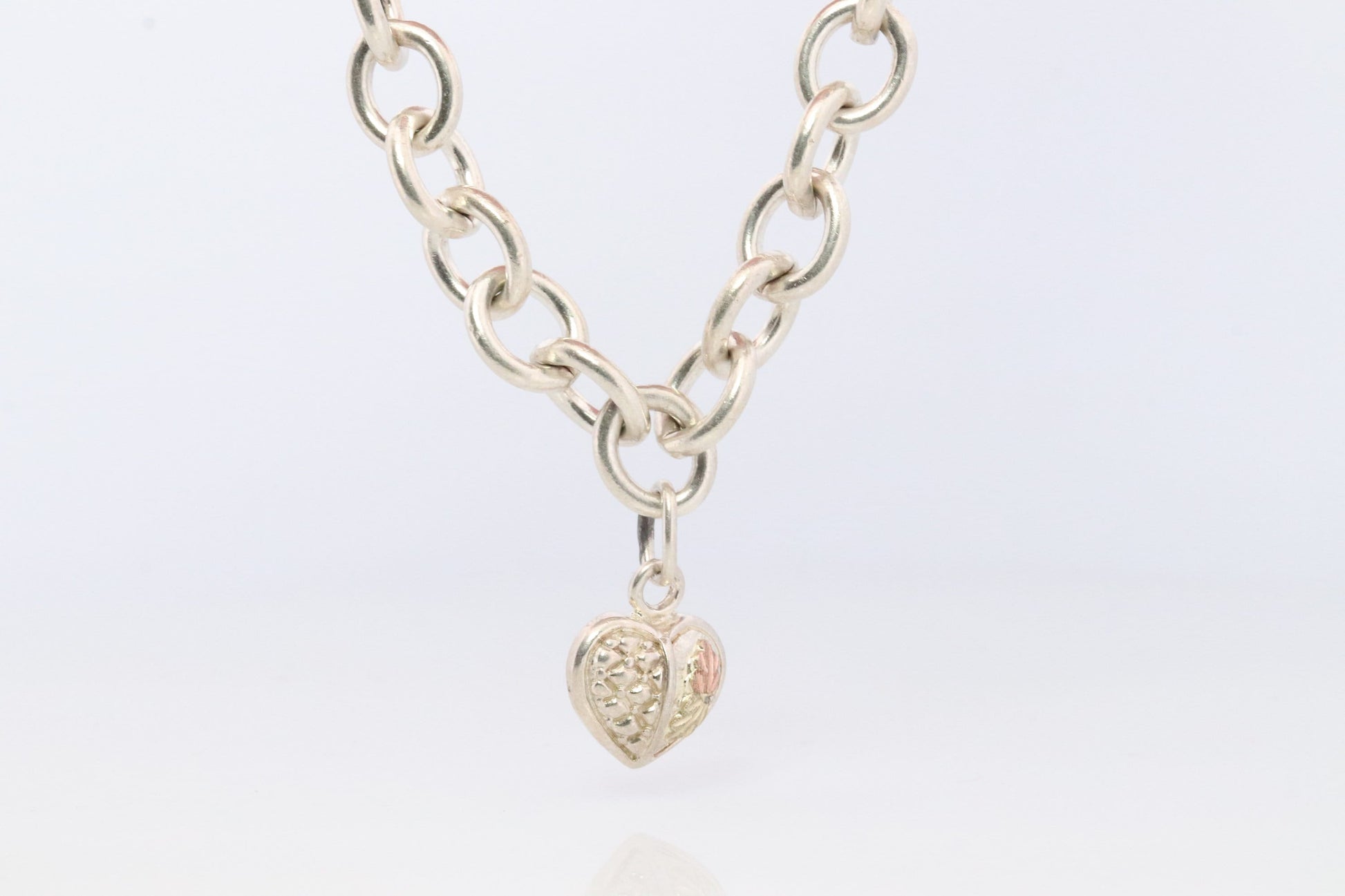 Black Hills Gold Bracelet. STERLING SILVER with 10k Multi-Tone Black Hills Gold. Large Cable with Heart charm.