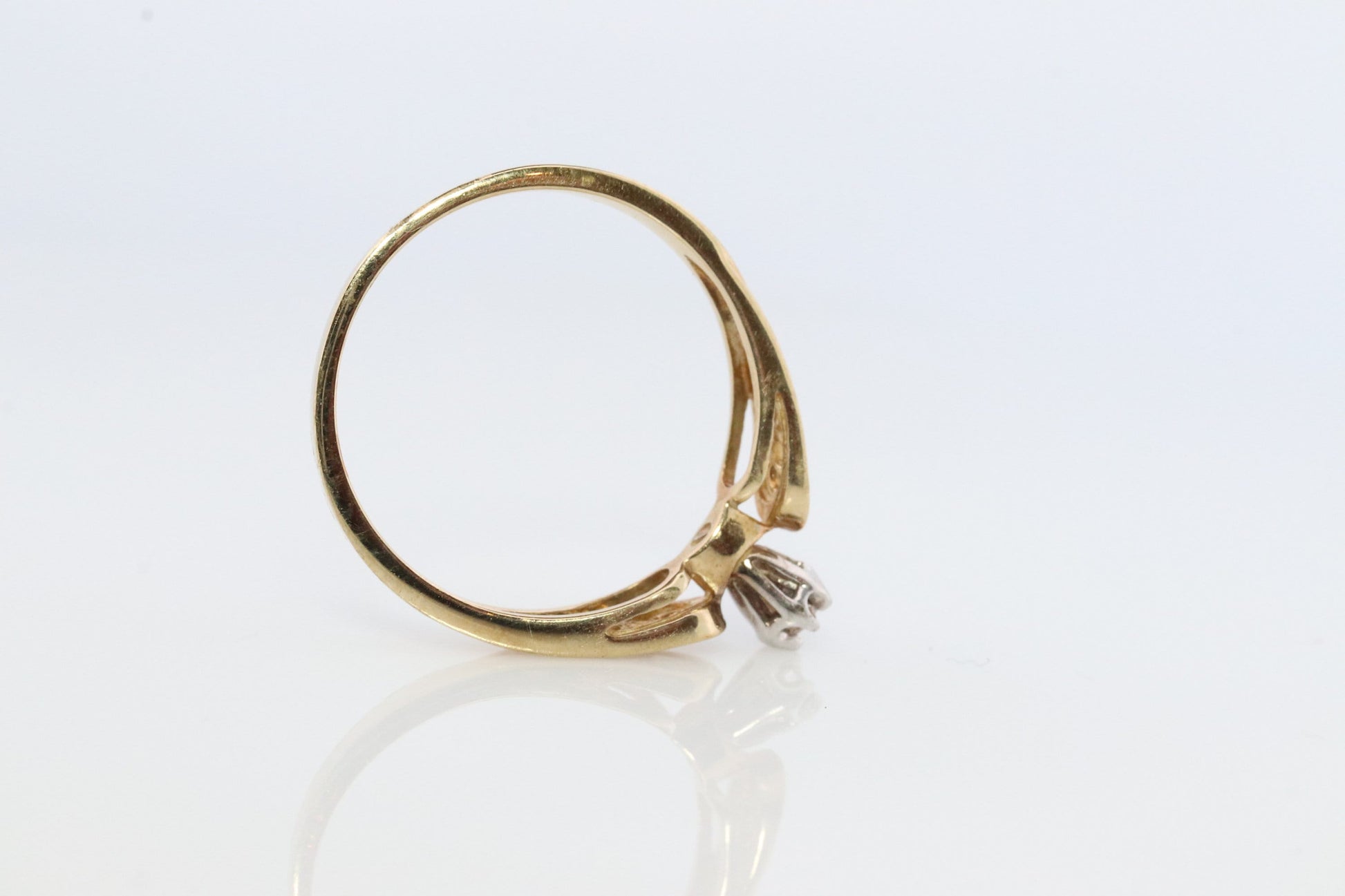 10k Diamond Solitaire. 10k Yellow gold engraved illusion set diamond ring. Filigree shank.