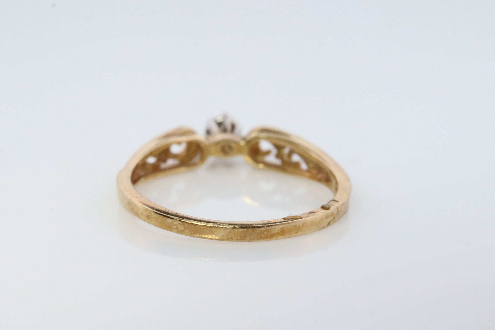 10k Diamond Solitaire. 10k Yellow gold engraved illusion set diamond ring. Filigree shank.