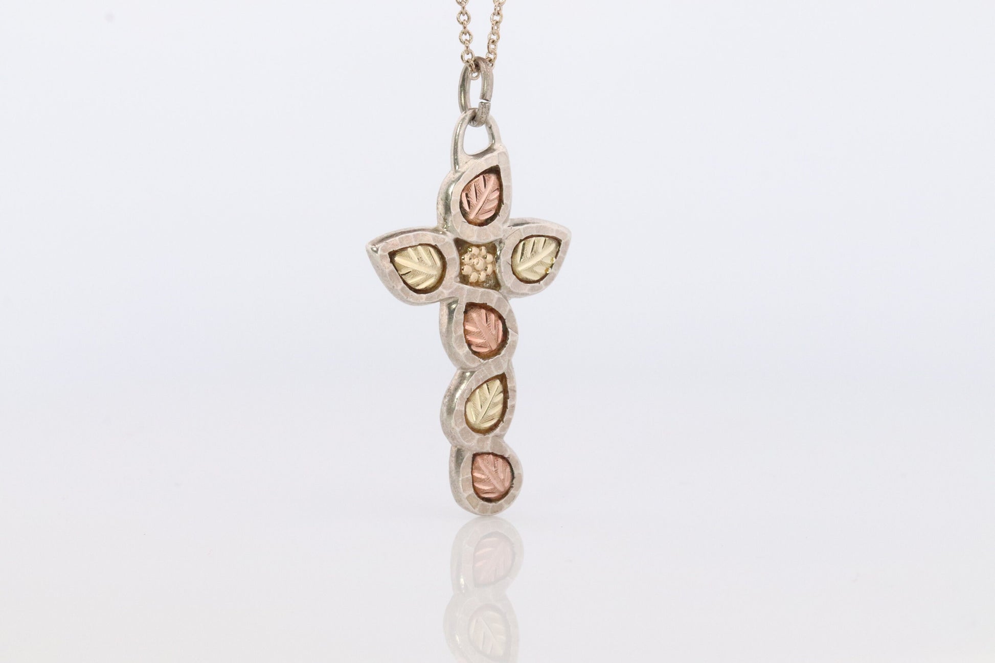 Black Hills Gold Cross Necklace. Sterling Silver with 10k/12k multi tone Black Hills Gold Crucifix Pendant.