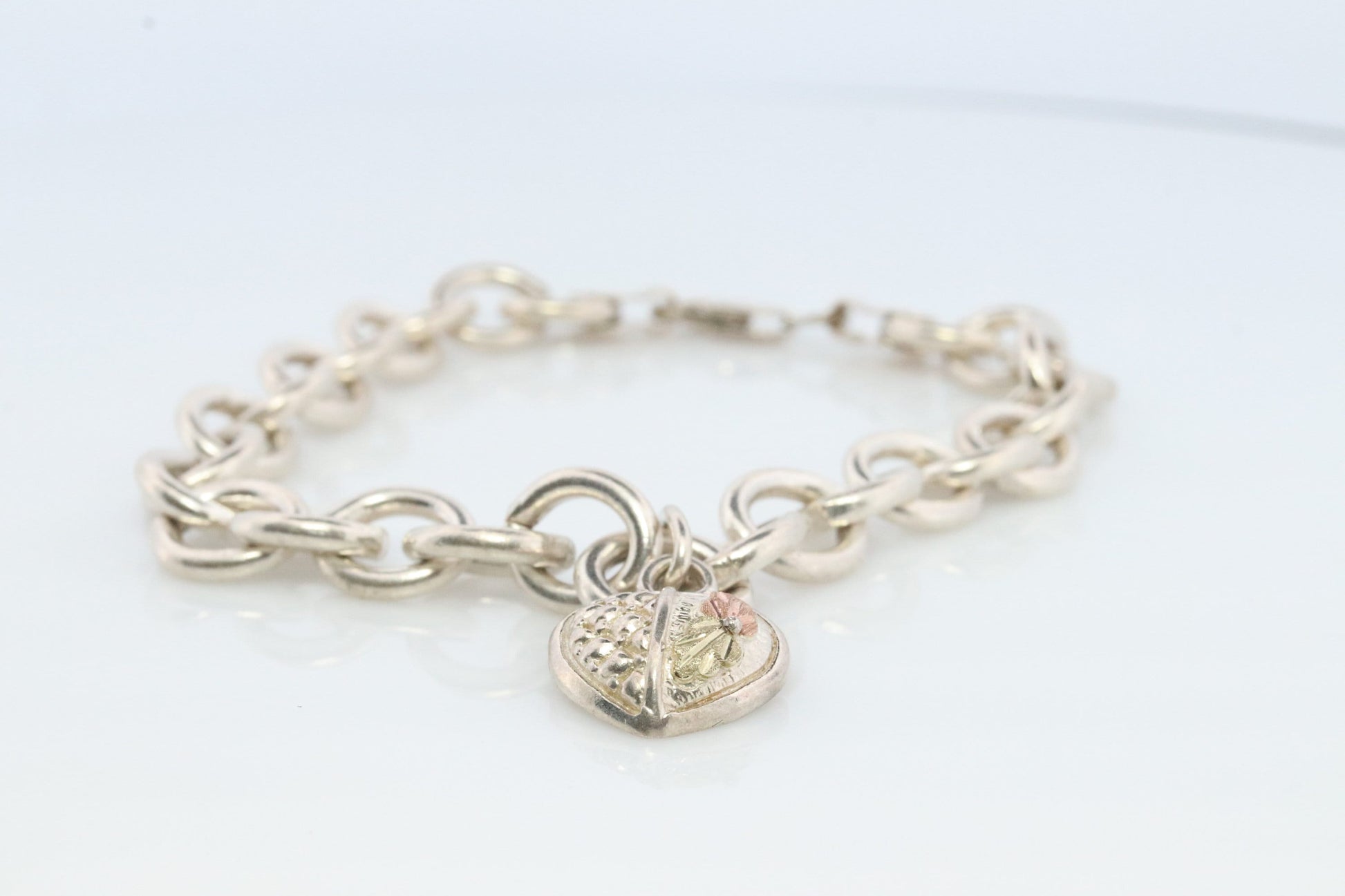 Black Hills Gold Bracelet. STERLING SILVER with 10k Multi-Tone Black Hills Gold. Large Cable with Heart charm.