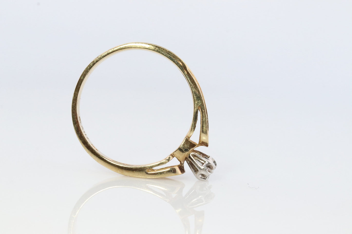 10k Diamond Solitaire. 10k Yellow gold engraved illusion set diamond ring. Filigree shank.