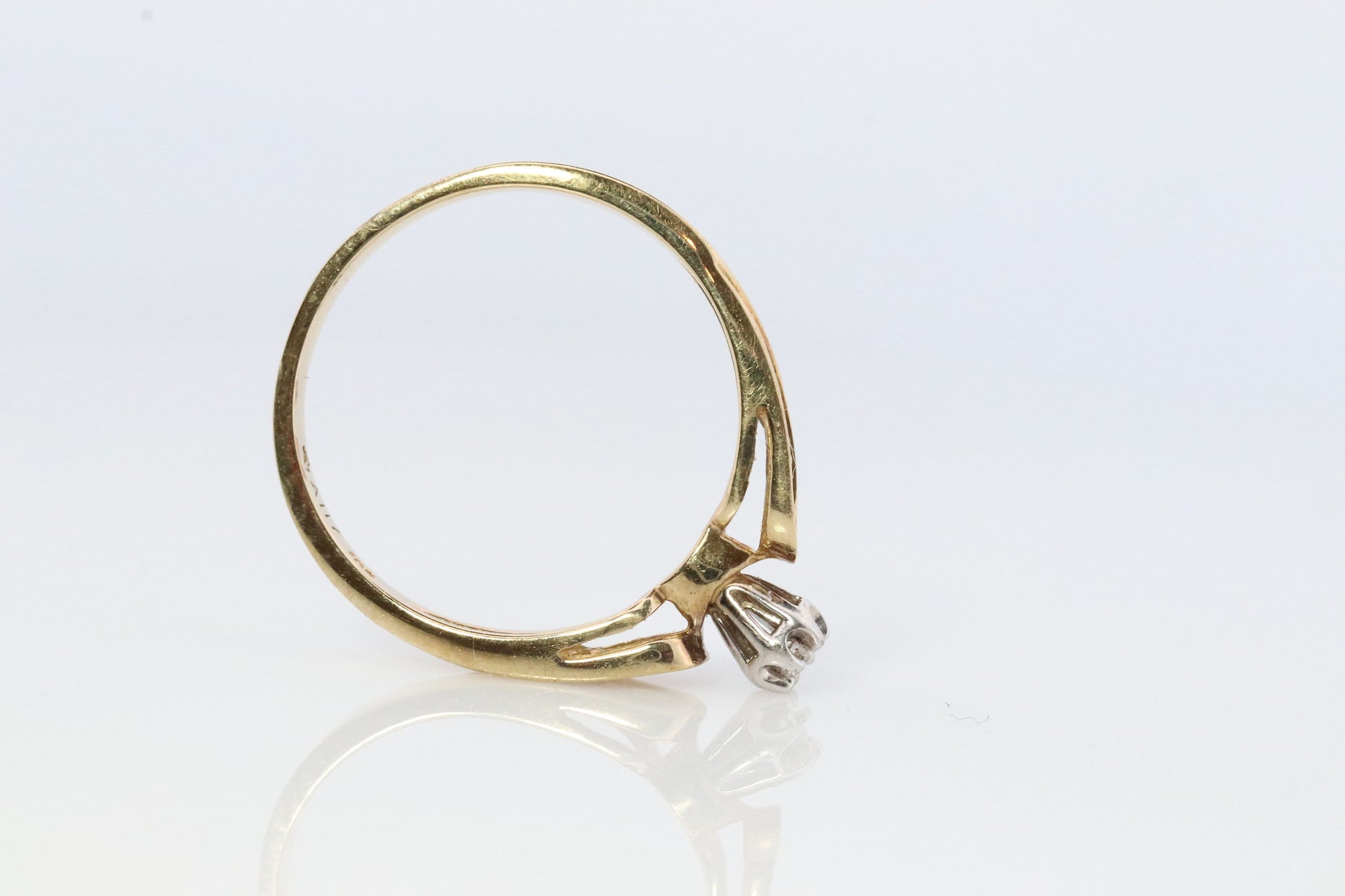 10k Diamond Solitaire. 10k Yellow gold engraved illusion set diamond ring. Filigree shank.