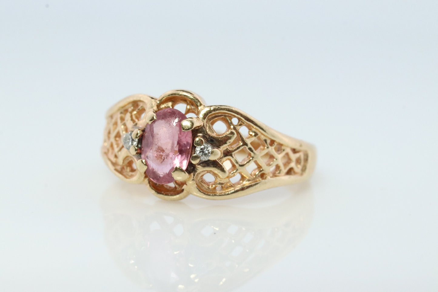 14k Pink Tourmaline Ring. prong set OVAL Tourmaline solitaire with diamond accents.