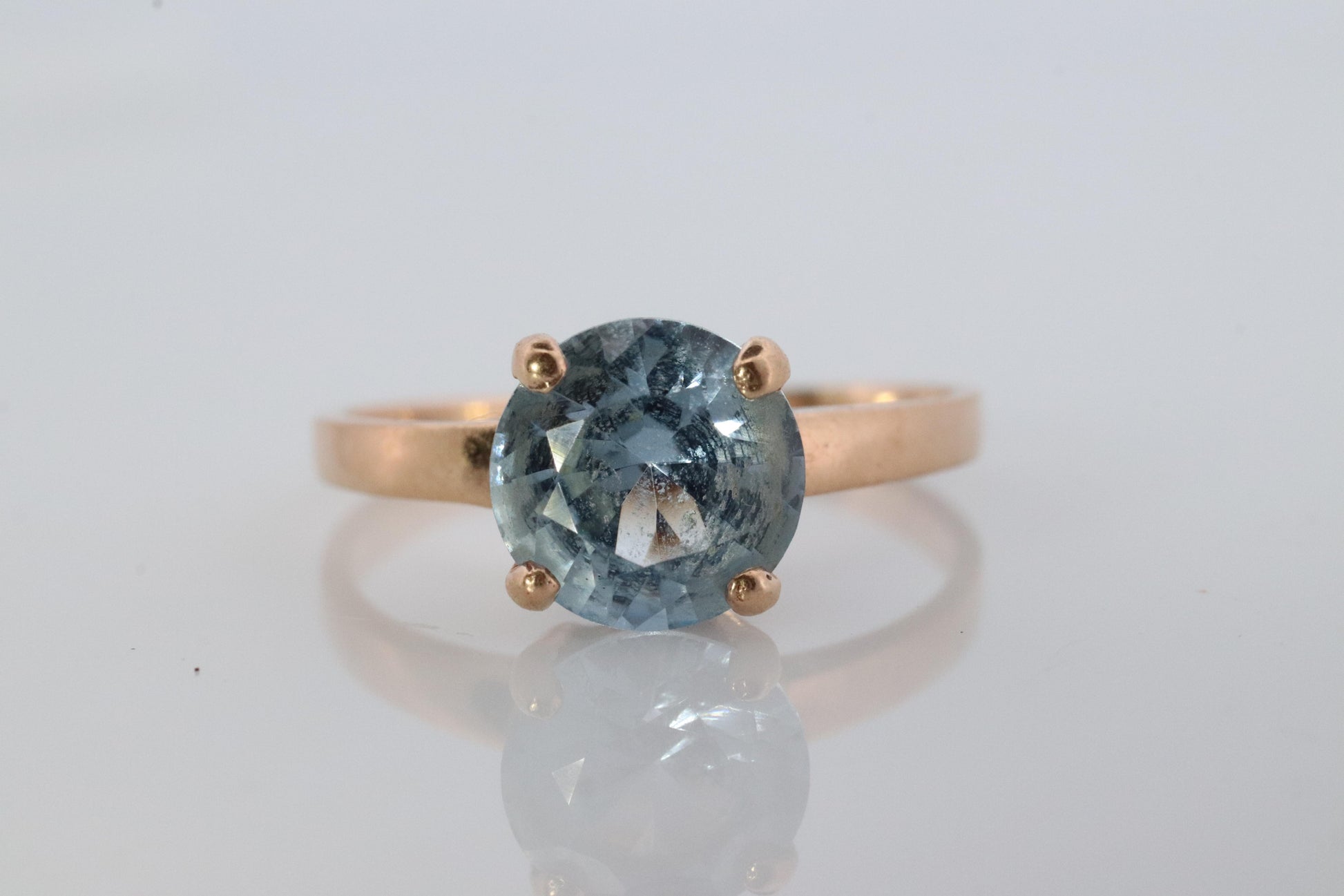 10k Aquamarine Topaz Solitaire Ring. 10k yellow gold band ring.