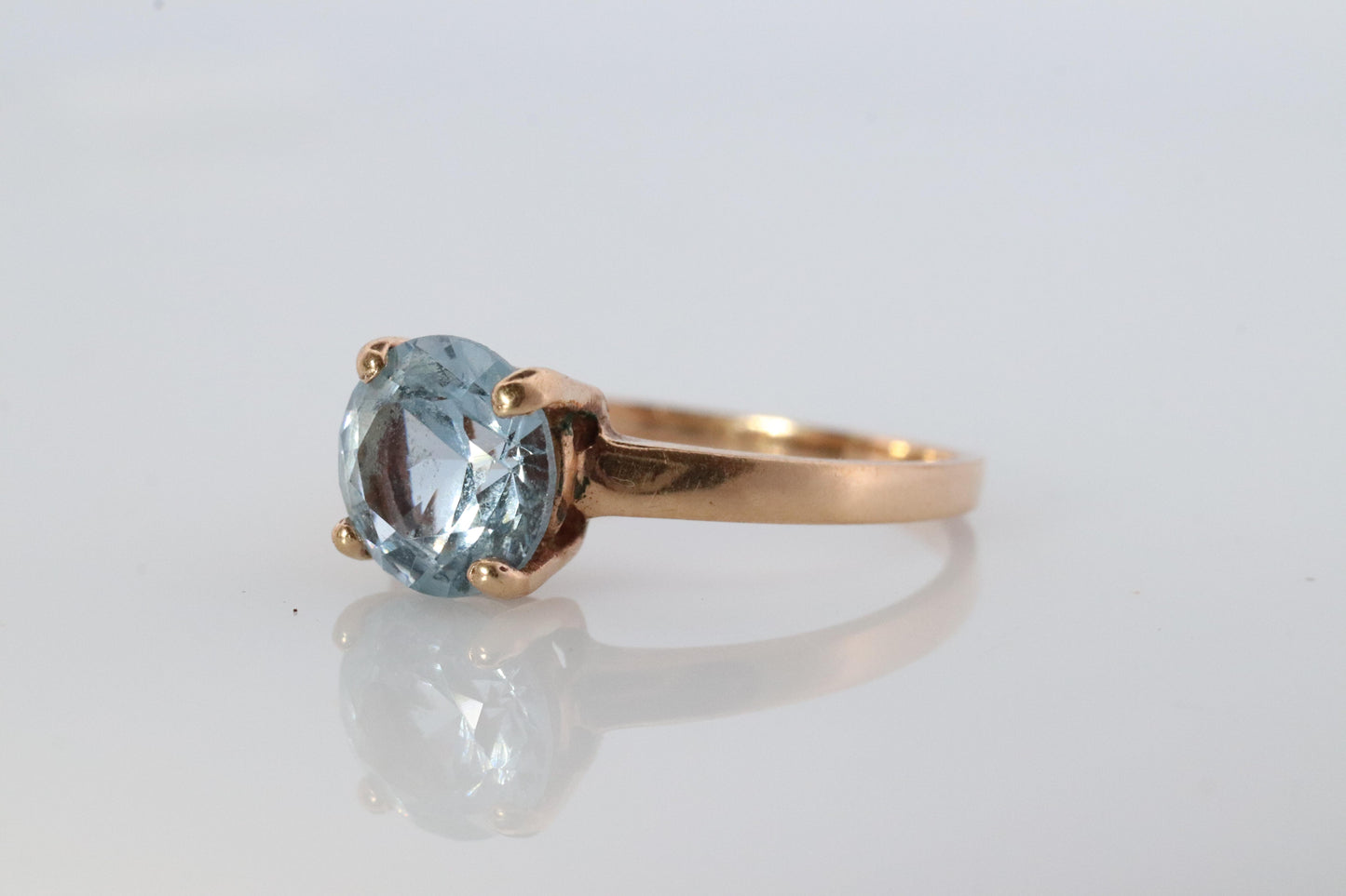 10k Aquamarine Topaz Solitaire Ring. 10k yellow gold band ring.