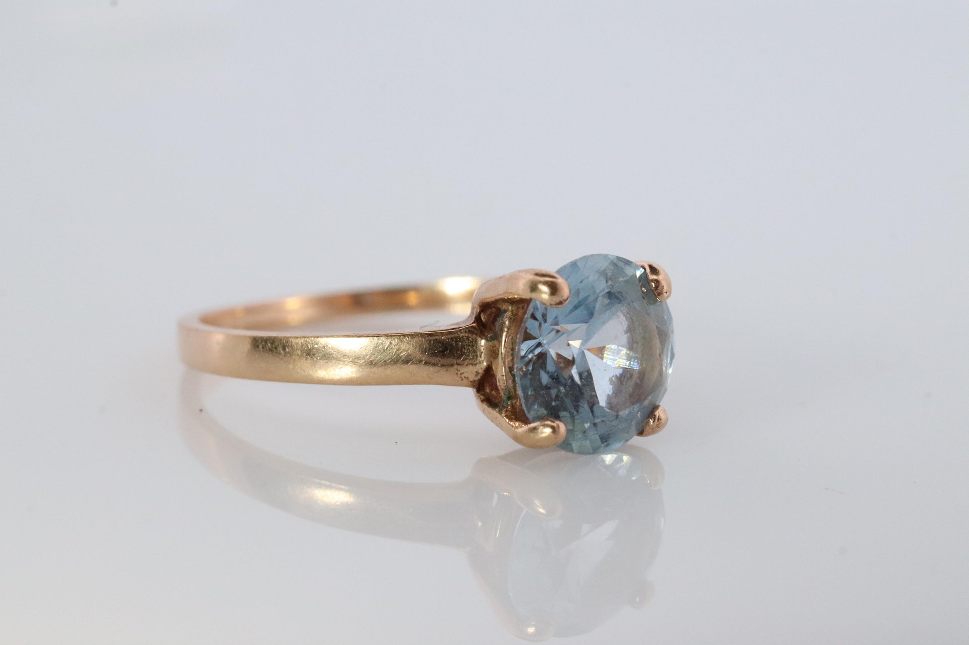 10k Aquamarine Topaz Solitaire Ring. 10k yellow gold band ring.