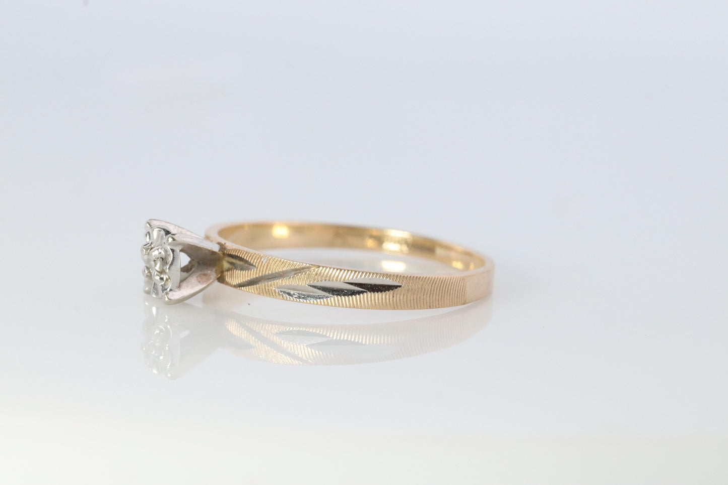 10k Diamond Solitaire. 10k Yellow gold engraved illusion set diamond ring.