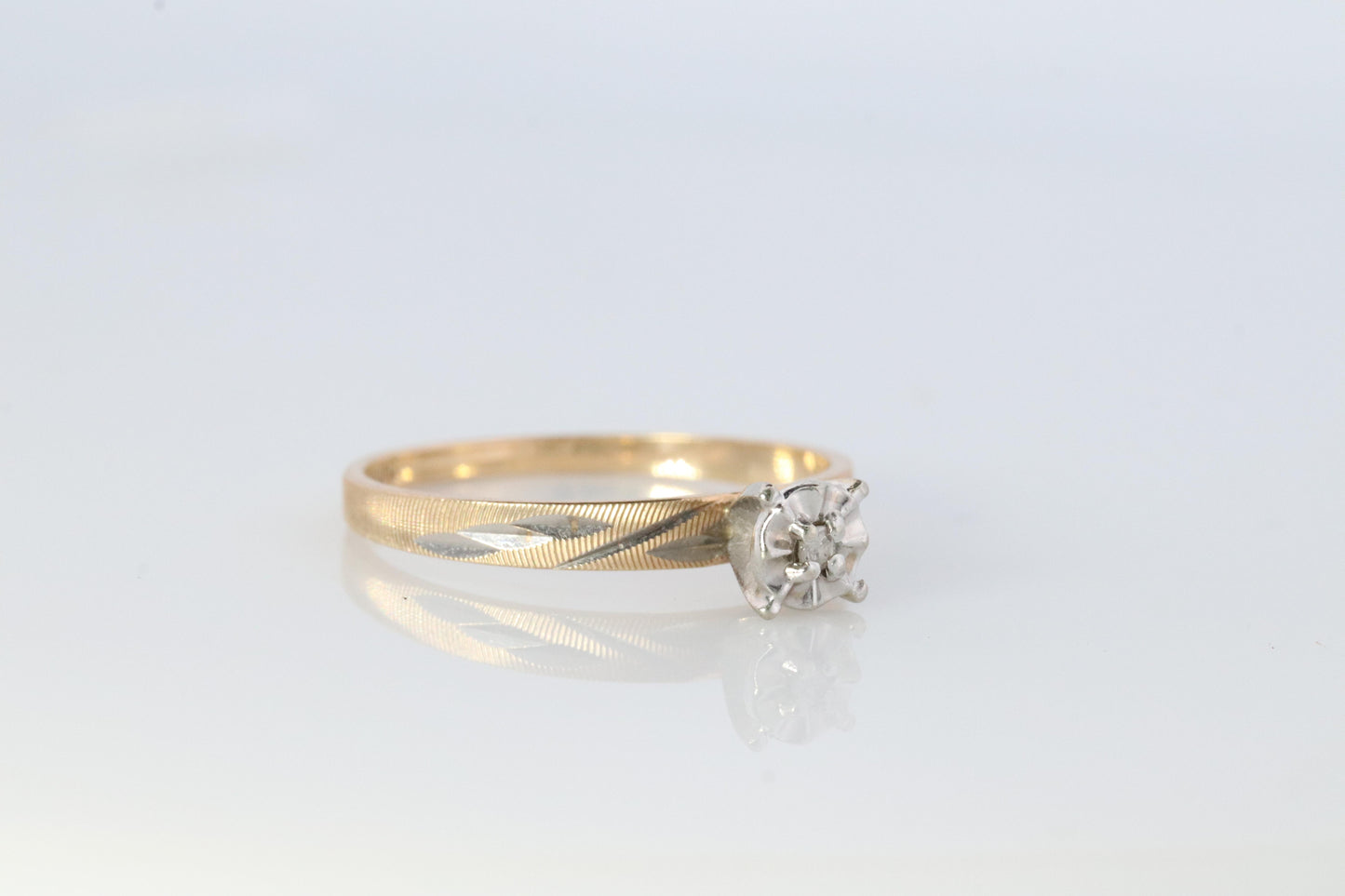 10k Diamond Solitaire. 10k Yellow gold engraved illusion set diamond ring.