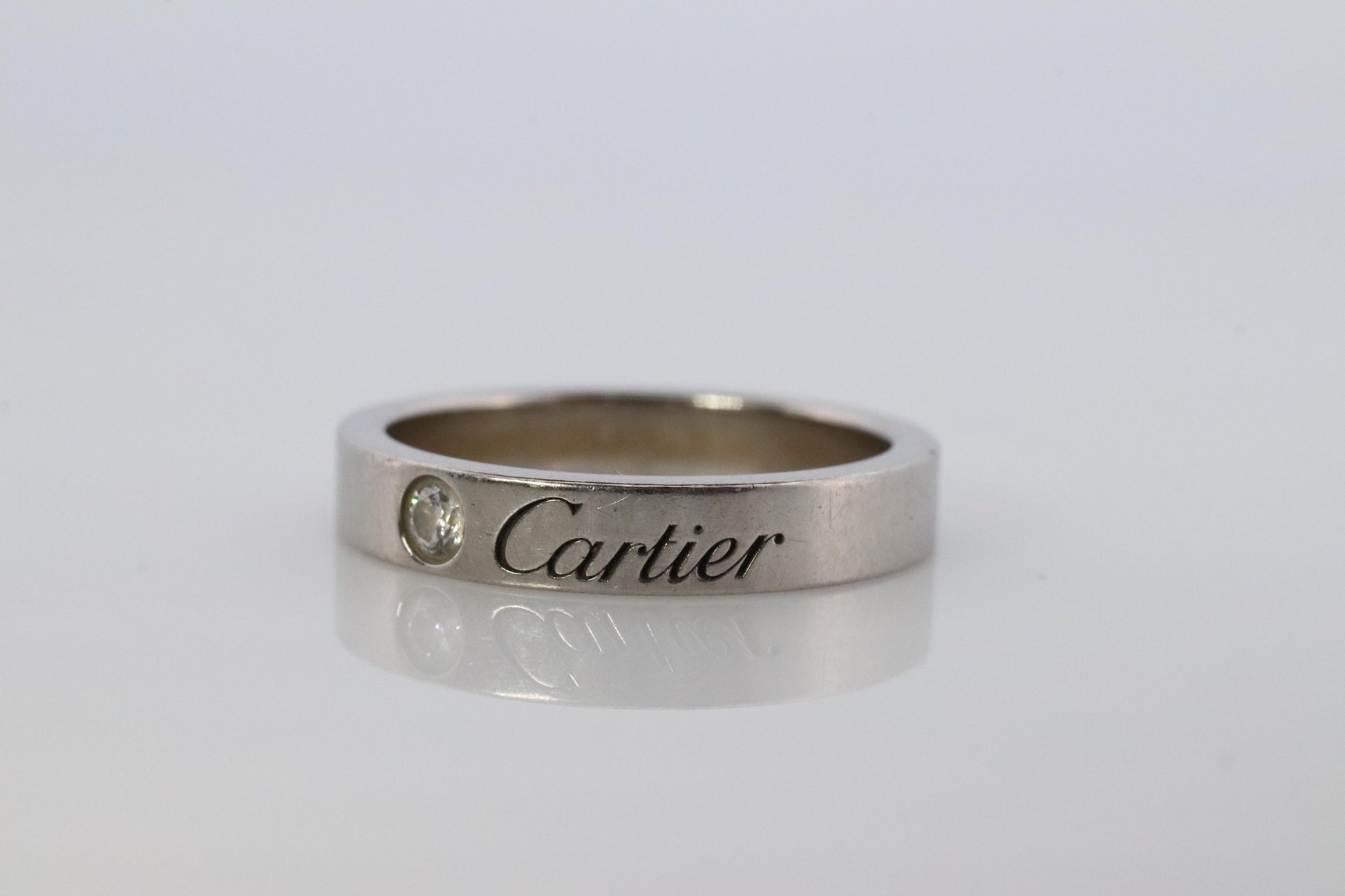 CARTIER Platinum  Ring. Cartier Diamond Signature Bezel 3mm Band.