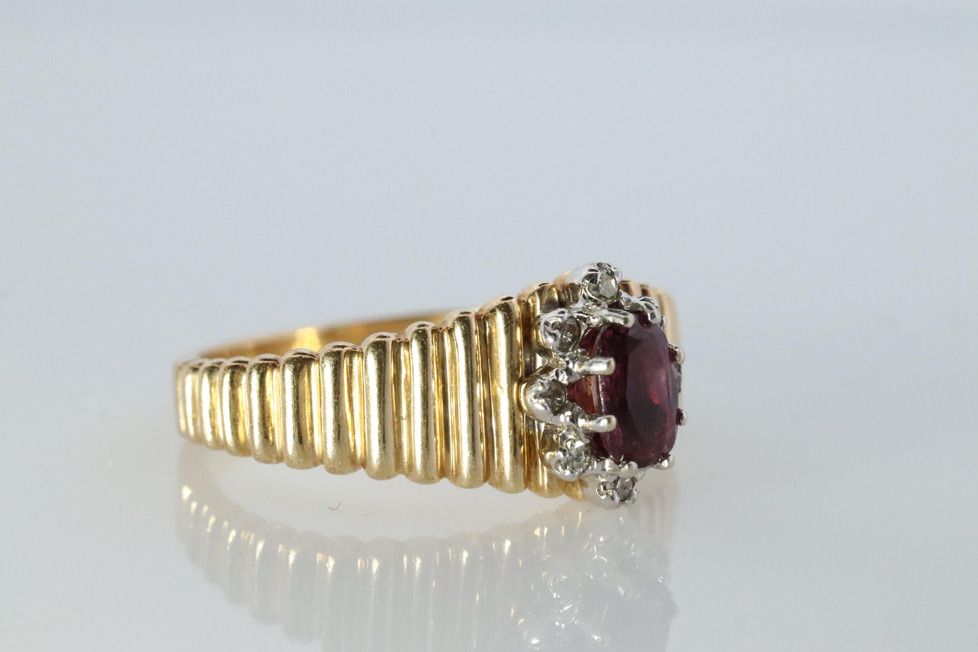 10k Ruby and Diamond HALO ring. 10k Yellow Gold Ribbed shank Ruby Halo ring.