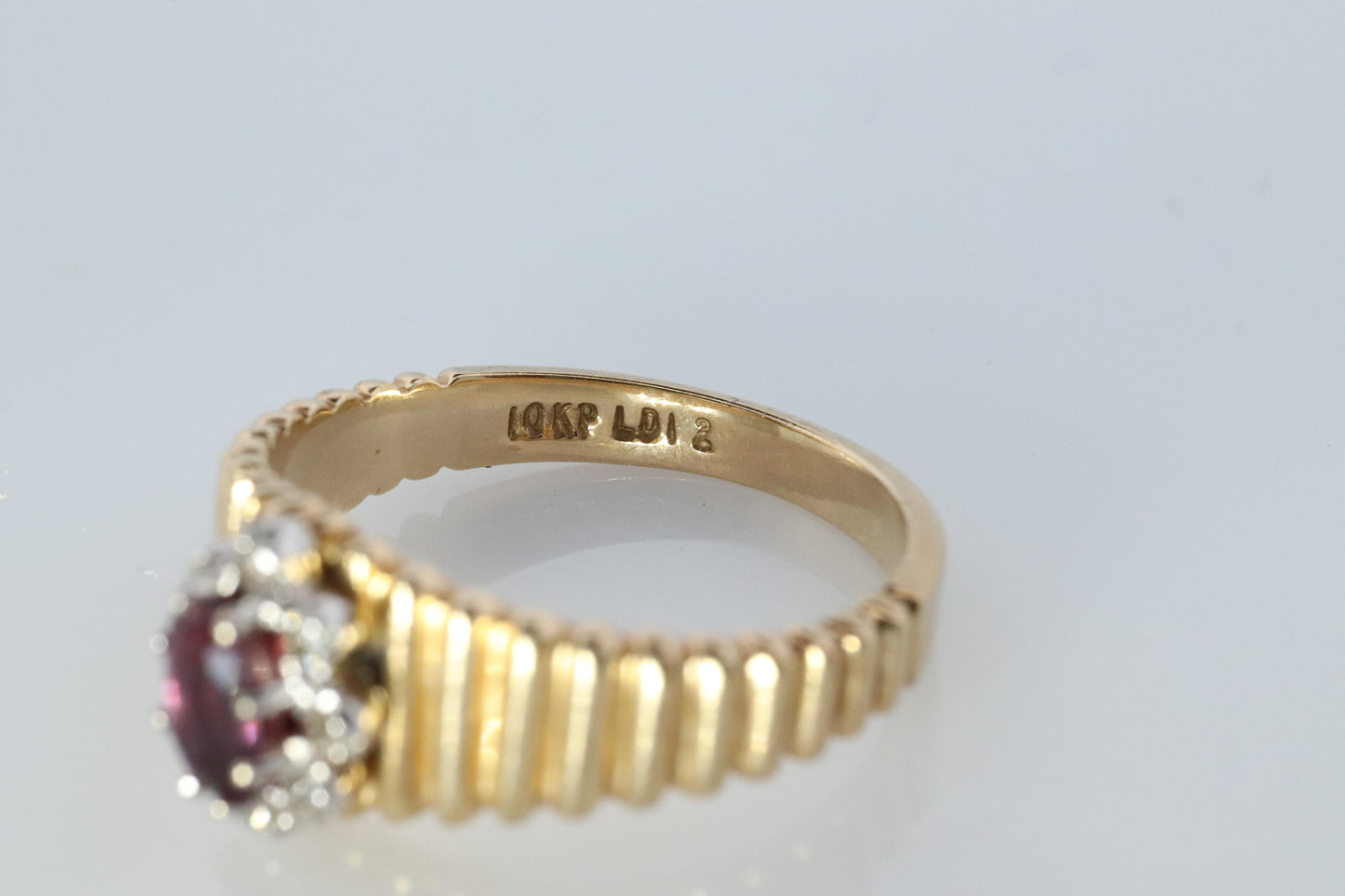 10k Ruby and Diamond HALO ring. 10k Yellow Gold Ribbed shank Ruby Halo ring.