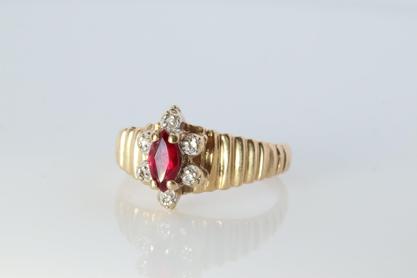 10k Ruby and Diamond HALO ring. 10k Yellow Gold Ribbed shank Ruby Halo ring.