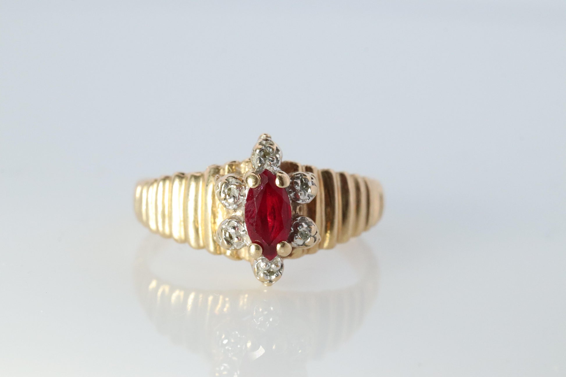 10k Ruby and Diamond HALO ring. 10k Yellow Gold Ribbed shank Ruby Halo ring.