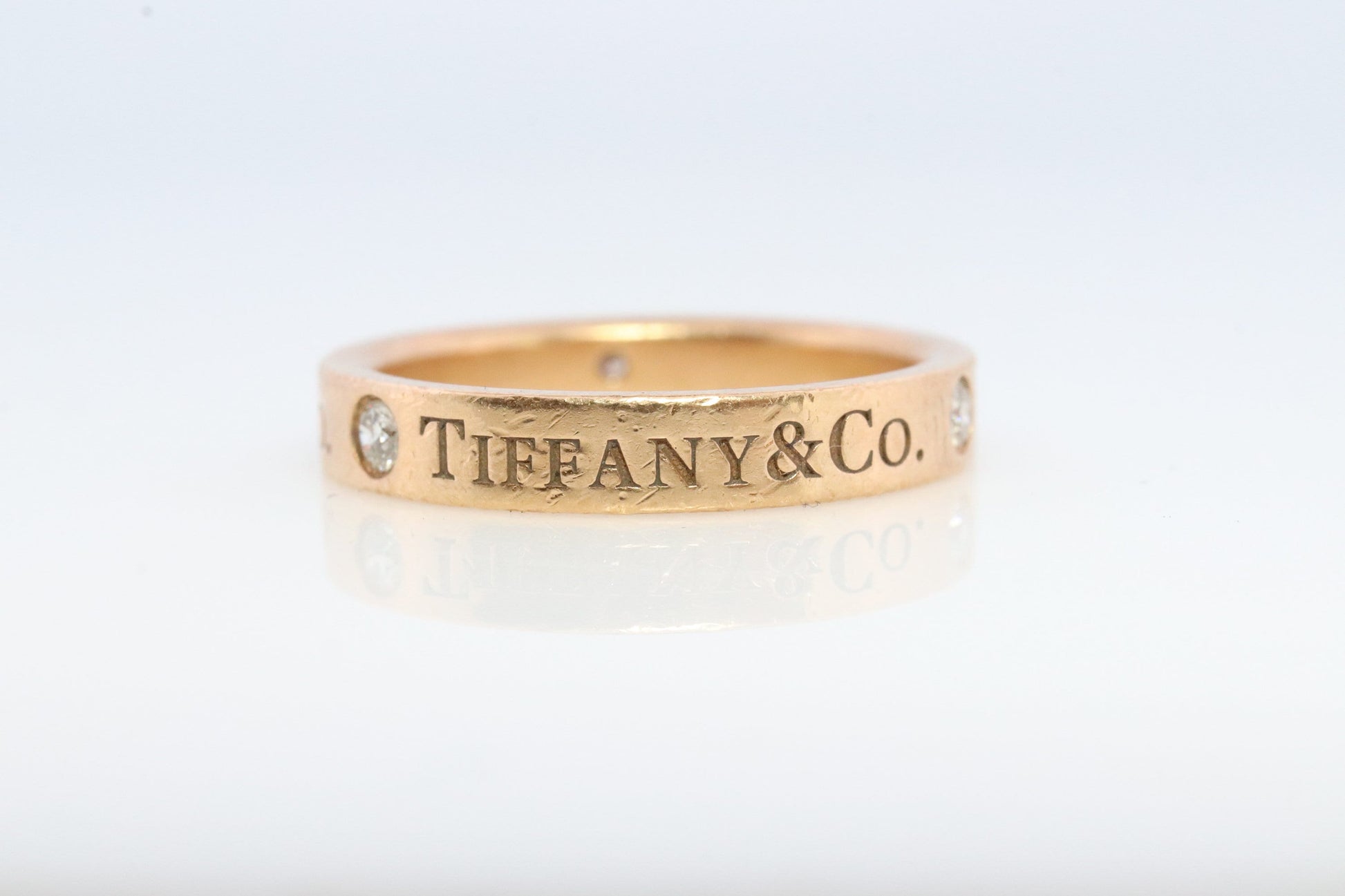 18k Tiffany and Co. band. 18k Tiffany Company Diamond wedding band. 18k Rose Gold Three diamond Bezel Vintage Tiffany & Co band.