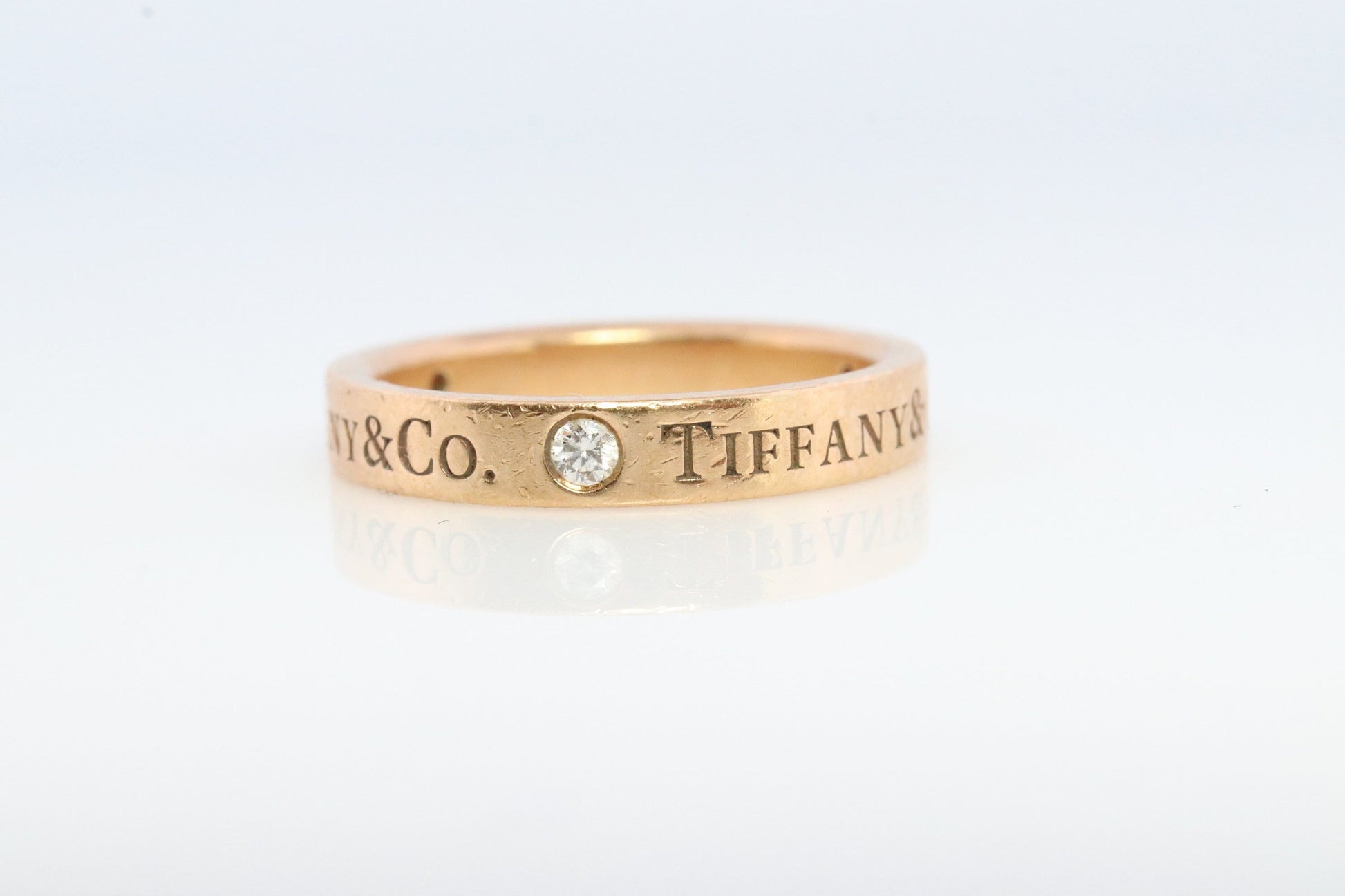 18k Tiffany and Co. band. 18k Tiffany Company Diamond wedding band. 18k Rose Gold Three diamond Bezel Vintage Tiffany & Co band.