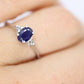 Platinum Sapphire and diamond ring. Oval blue Sapphire solitaire with Diamond accents trilogy ring.