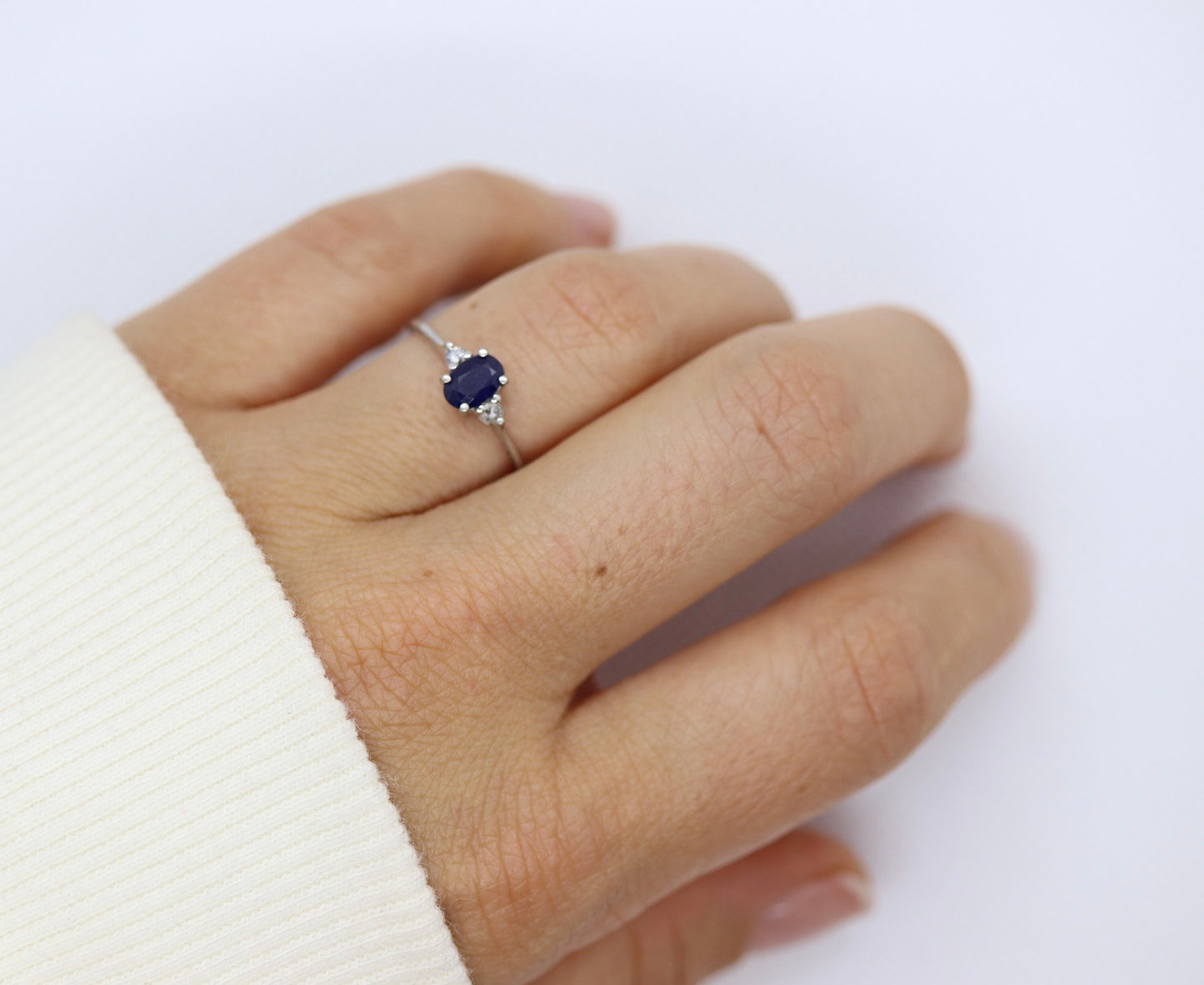 Platinum Sapphire and diamond ring. Oval blue Sapphire solitaire with Diamond accents trilogy ring.