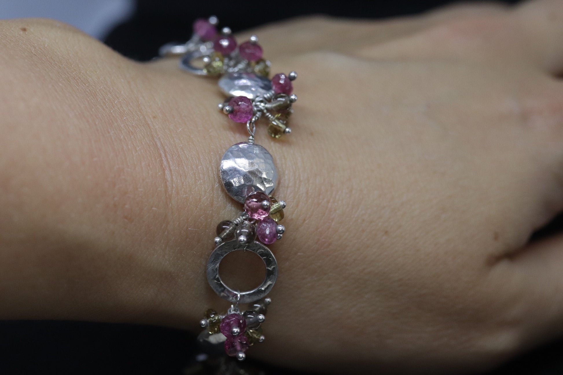 Laura Gibson Bracelet. Sterling Silver with Dangling Faceted Gems -Pink Tourmaline, Smokey Quartz, and Whiskey Quartz (289)