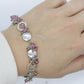Laura Gibson Bracelet. Sterling Silver with Dangling Faceted Gems -Pink Tourmaline, Smokey Quartz, and Whiskey Quartz (289)