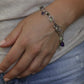 Laura Gibson Bracelet. Sterling Silver with Dangling Faceted Gems - Amethyst (464)
