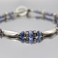 Laura Gibson Bracelet. Sterling Silver and with Dangling Faceted Gems - Topaz -  (595)