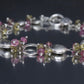 Laura Gibson Bracelet. Sterling Silver with Dangling Faceted Gems -Pink Tourmaline, Smokey Quartz, and Whiskey Quartz (289)