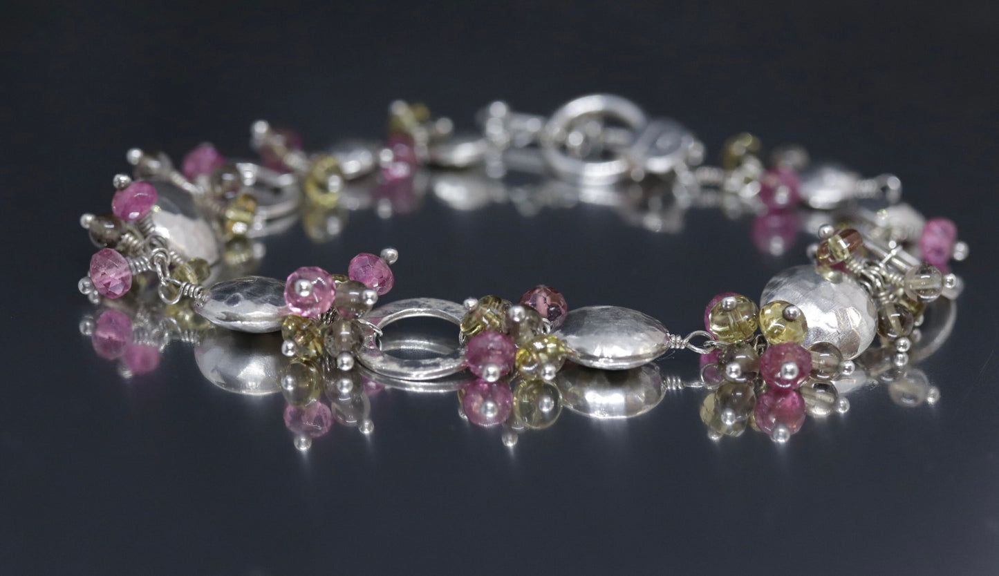 Laura Gibson Bracelet. Sterling Silver with Dangling Faceted Gems -Pink Tourmaline, Smokey Quartz, and Whiskey Quartz (289)