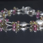 Laura Gibson Bracelet. Sterling Silver with Dangling Faceted Gems -Pink Tourmaline, Smokey Quartz, and Whiskey Quartz (289)