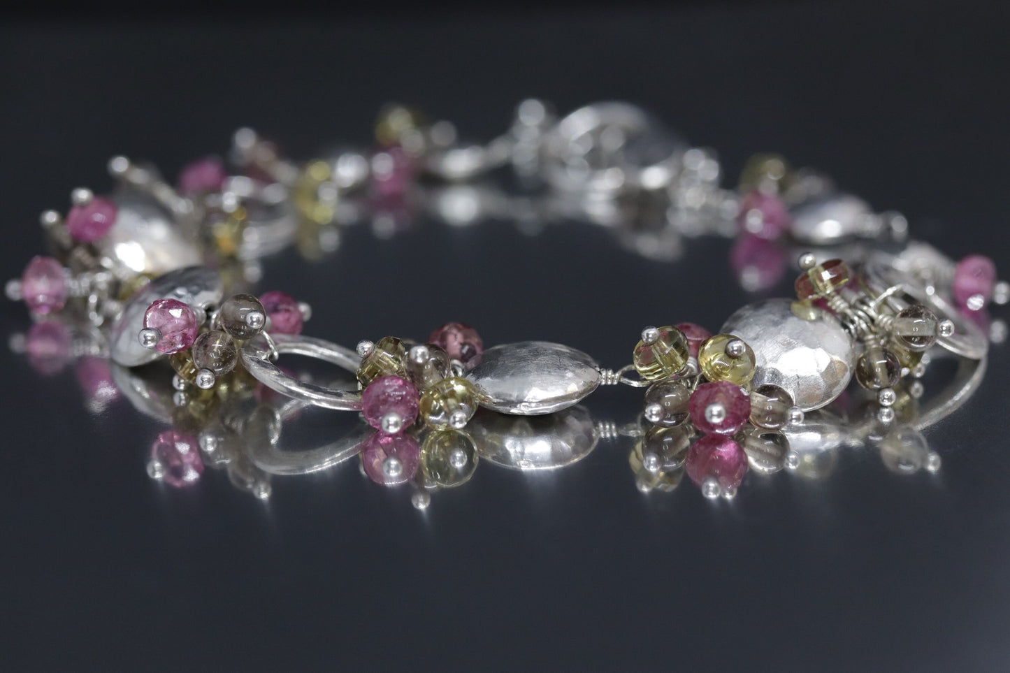 Laura Gibson Bracelet. Sterling Silver with Dangling Faceted Gems -Pink Tourmaline, Smokey Quartz, and Whiskey Quartz (289)