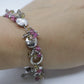 Laura Gibson Bracelet. Sterling Silver with Dangling Faceted Gems -Pink Tourmaline, Smokey Quartz, and Whiskey Quartz (289)