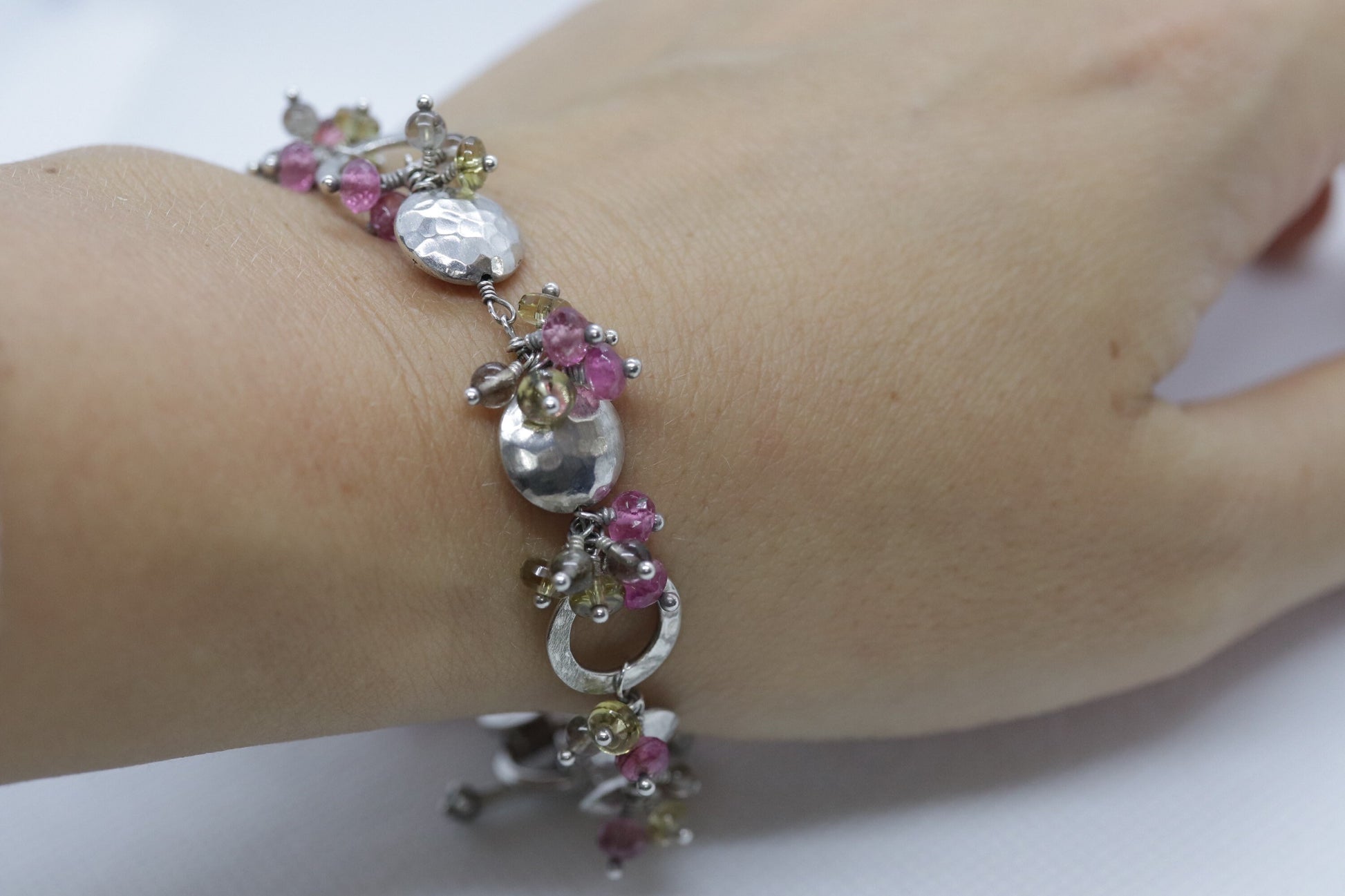 Laura Gibson Bracelet. Sterling Silver with Dangling Faceted Gems -Pink Tourmaline, Smokey Quartz, and Whiskey Quartz (289)