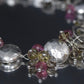Laura Gibson Bracelet. Sterling Silver with Dangling Faceted Gems -Pink Tourmaline, Smokey Quartz, and Whiskey Quartz (289)