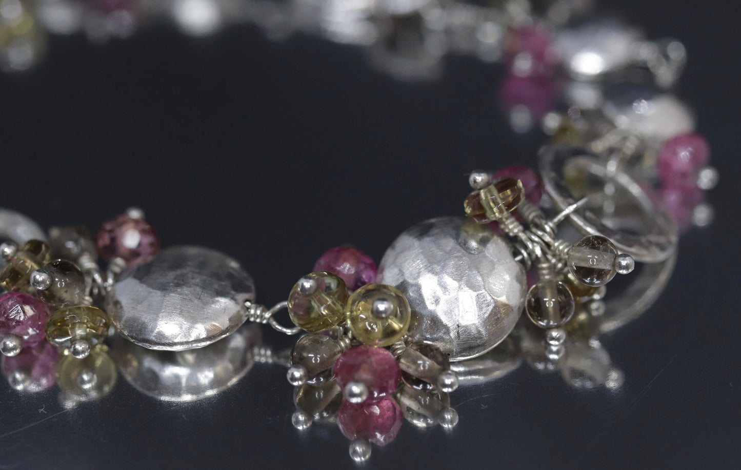 Laura Gibson Bracelet. Sterling Silver with Dangling Faceted Gems -Pink Tourmaline, Smokey Quartz, and Whiskey Quartz (289)