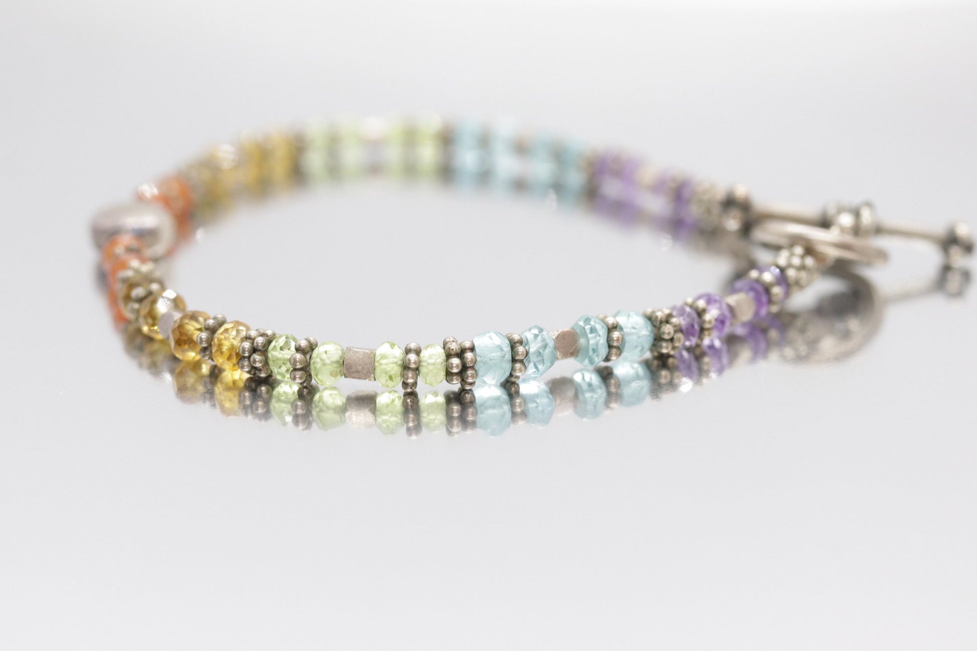 Laura Gibson Bracelet. Sterling Silver with Dangling Faceted Gems - (298)