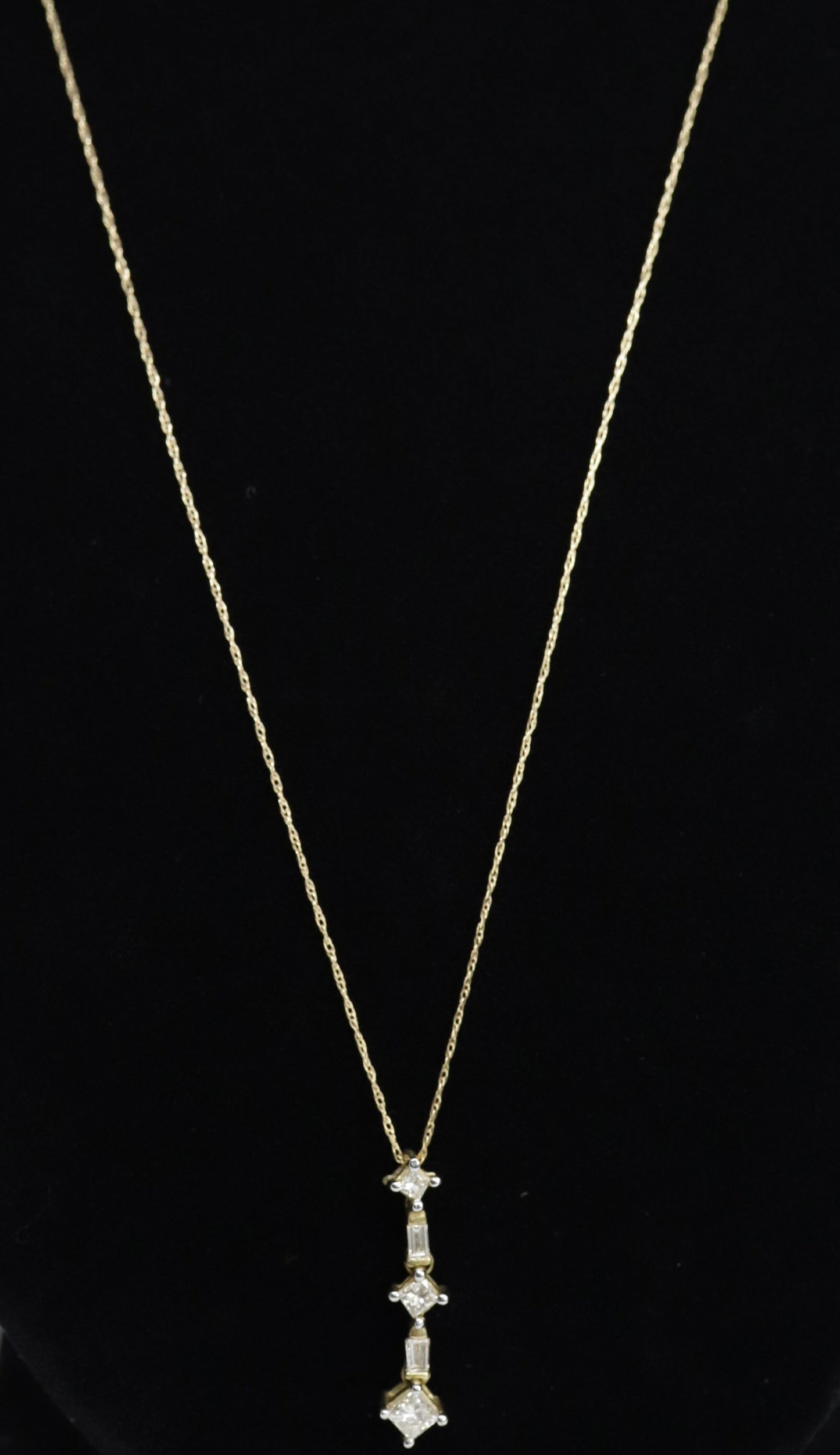 10k 3 Diamond Past Present Future Journey Pendant. 0.60ctw Princess and Baguette diamonds. 10k Yellow gold Rope necklace. (88)