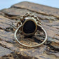 Oval Onyx ring. 10k ornate gold frame onyx ring. Mourning ring. St(103/50)