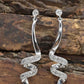 10k Diamond Earrings. Diamond Swirl Drop Dangle Earrings. 10k white gold. st(92/11)