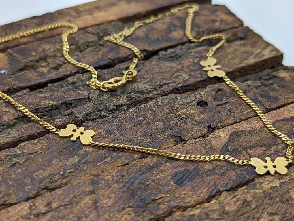 14k Butterfly Necklace. Multiple Butterfly pendants on a necklace. Yellow gold curb chain. st77/60