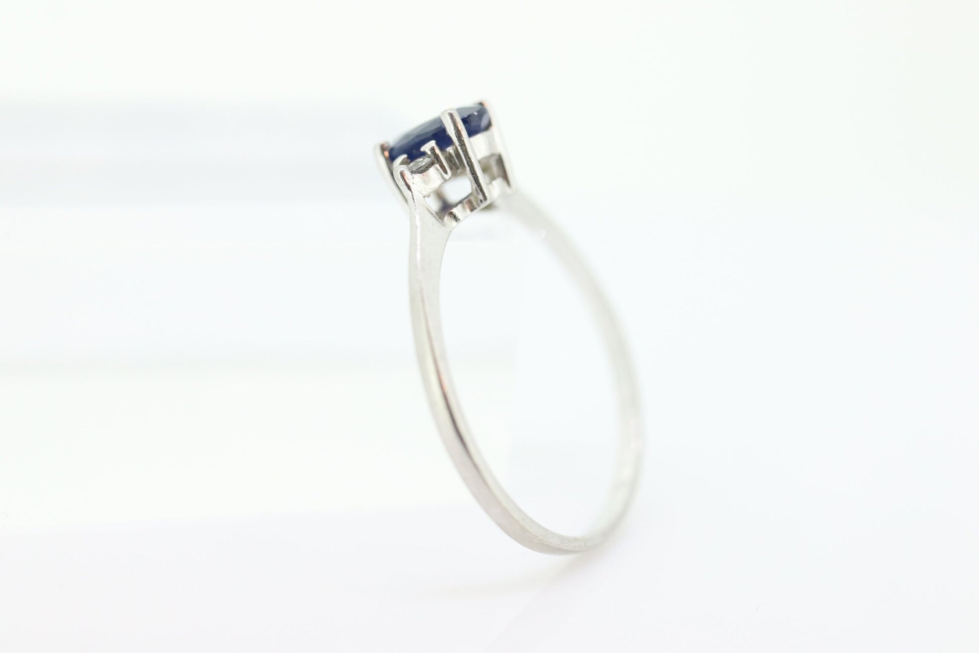 Platinum Sapphire and diamond ring. Oval blue Sapphire solitaire with Diamond accents trilogy ring.