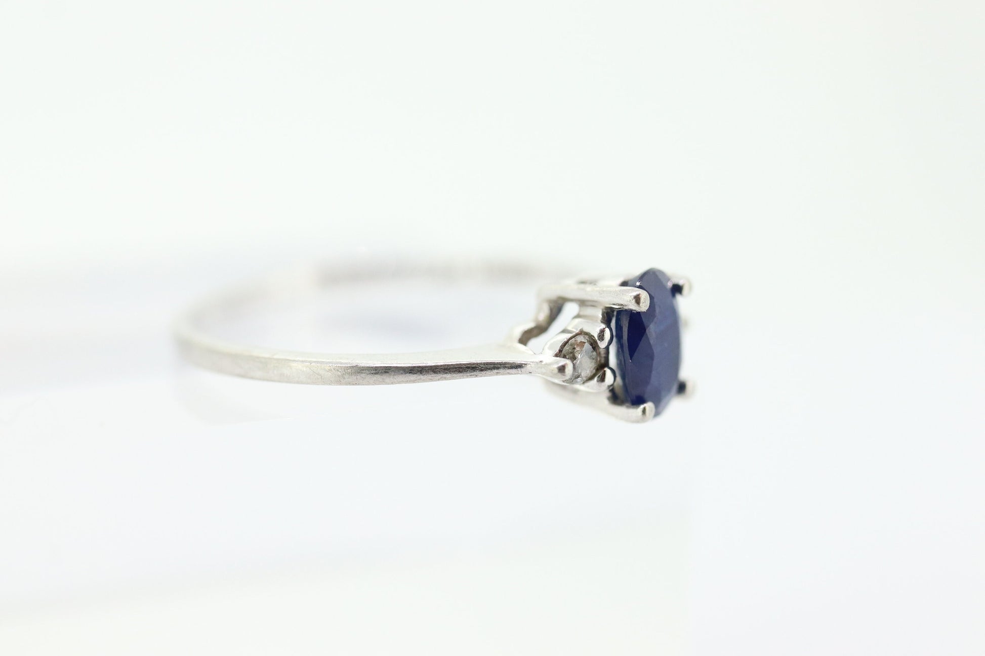 Platinum Sapphire and diamond ring. Oval blue Sapphire solitaire with Diamond accents trilogy ring.