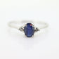 Platinum Sapphire and diamond ring. Oval blue Sapphire solitaire with Diamond accents trilogy ring.