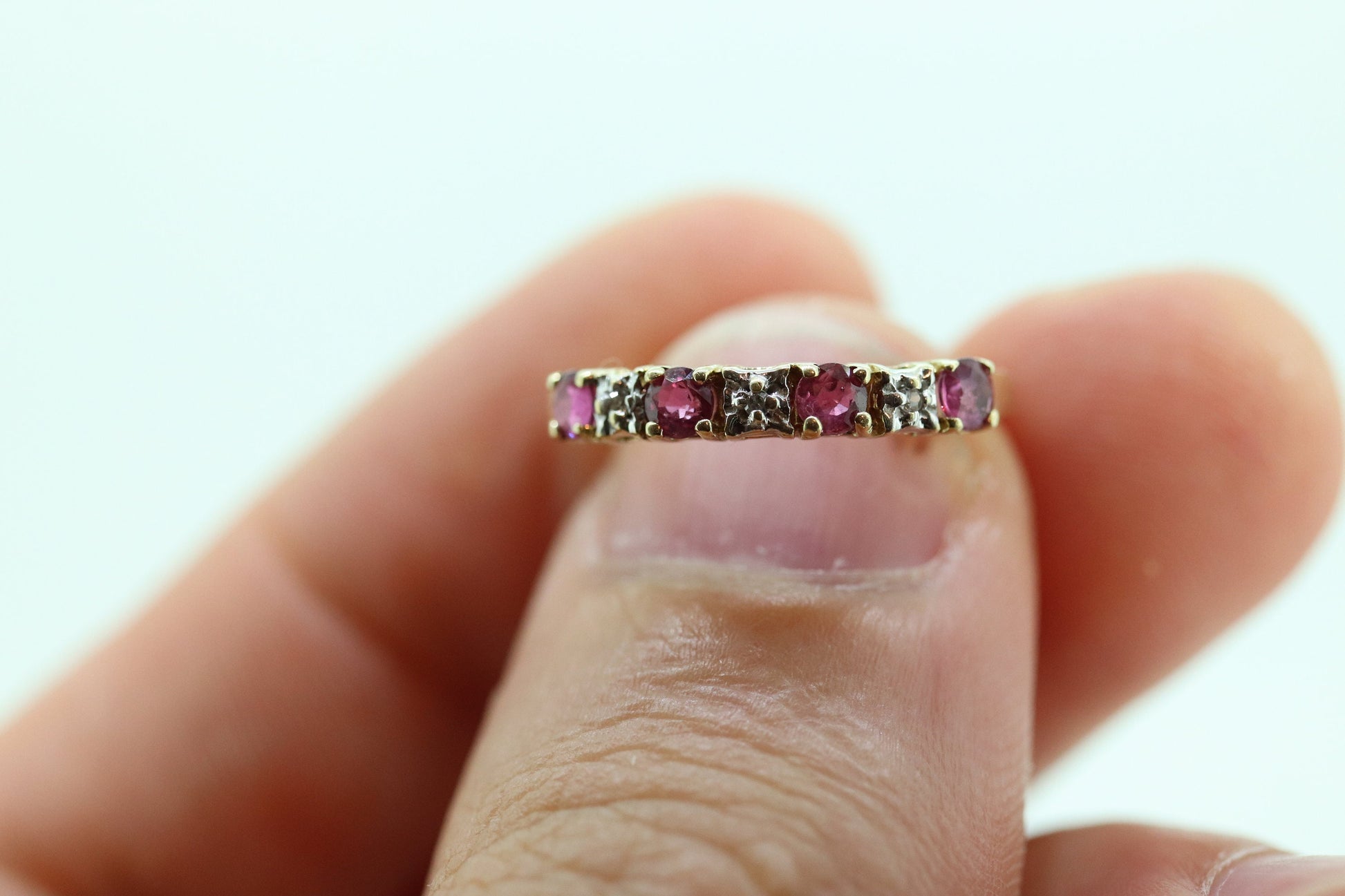 10k Anniversary Ruby Ring. A 10k gold ring with round Ruby and diamond accents eternity band. st(72)