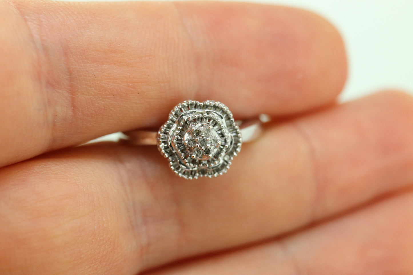 Diamond Daisy Cluster Elevated Ring. 10k White gold with round baguette diamond flower arrangement. st(52/90)